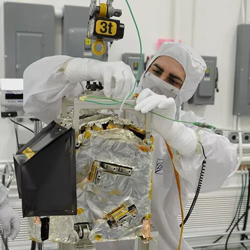 A Ball Aerospace technician using a Ron 2501 dynamometer in a sensitive aerospace lab application.